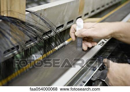 Fabric coating plant, weaving department, mechanist preparing weaver's reed on loom View Large Photo Image Stock Photo - Fabric coating plant, weaving department, mechanist preparing weaver's reed on loom. Fotosearch