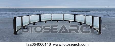 Flat screen televisions with images of wind turbines lined up on beach View Large Photo Image Stock Photograph - Flat screen televisions with images of wind turbines lined up on beach. Fotosearch