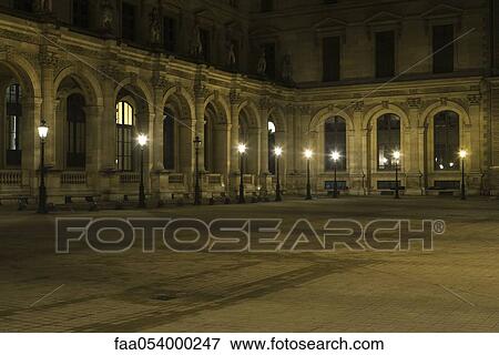 Stock Photo - France, Paris, courtyard of The Louvre at night. Fotosearch