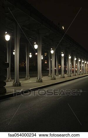 Picture - France, Paris, Pont Bir Hakeim bridge at night. Fotosearch