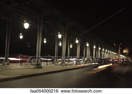 Stock Photograph - France, Paris, traffic moving on Pont Bir Hakeim at night. Fotosearch