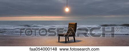 Stock Photo - Light bulb illuminated over chair on beach at sunset. Fotosearch