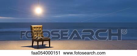 Stock Image - Light bulb illuminated over chair with open book on beach at night. Fotosearch