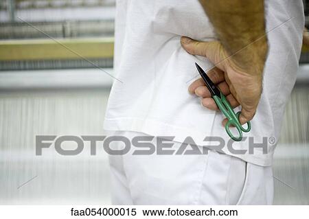 Machinist standing next to loom in weaving mill, holding pair of scissors View Large Photo Image Stock Photography - Machinist standing next to loom in weaving mill, holding pair of scissors. Fotosearch