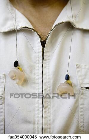 Machinist wearing earplugs around neck View Large Photo Image Stock Photography - Machinist wearing earplugs around neck. Fotosearch