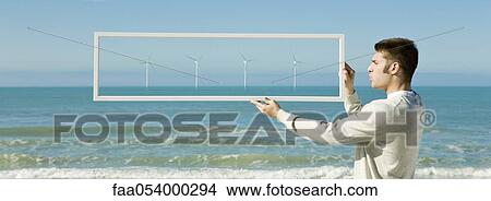 Offshore wind turbines on horizon viewed from beach View Large Photo Image Picture - Offshore wind turbines on horizon viewed from beach. Fotosearch