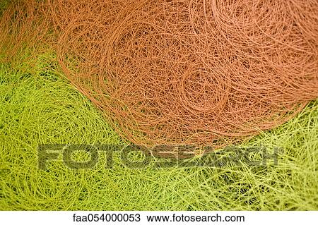 Stock Image - Recyclable composite textile fabrication department of factory, coated thread in a trash bin. Fotosearch