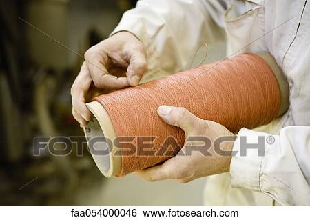 Recyclable composite textile fabrication department of factory, worker performing quality control on thread View Large Photo Image Stock Photograph - Recyclable composite textile fabrication department of factory, worker performing quality control on thread. Fotosearch