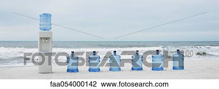 Water cooler and water jugs lined up on beach View Large Photo Image Stock Image - Water cooler and water jugs lined up on beach. Fotosearch