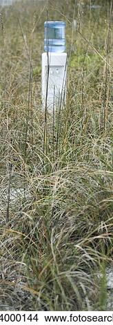Water cooler in field of dry grass View Large Photo Image Picture - Water cooler in field of dry grass. Fotosearch