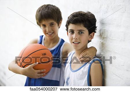 Stock Photo - Young basketball players, portrait. Fotosearch