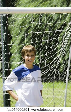 Young soccer player in front of goal View Large Photo Image Stock Image - Young soccer player in front of goal. Fotosearch
