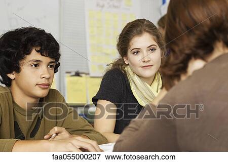 Classmates chatting together View Large Photo Image Stock Photo - Classmates chatting together. Fotosearch