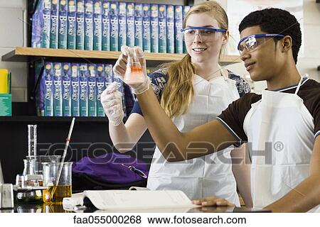 Classmates conducting experiment in chemistry class View Large Photo Image Stock Photo - Classmates conducting experiment in chemistry class. Fotosearch