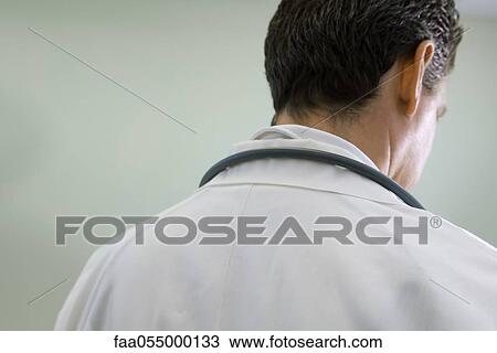 Doctor contemplatively looking down View Large Photo Image Stock Image - Doctor contemplatively looking down. Fotosearch