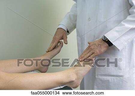 Doctor examining patient's feet View Large Photo Image Picture - Doctor examining patient's feet. Fotosearch