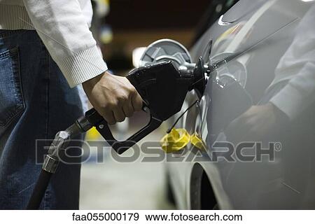 Driver refueling car View Large Photo Image Stock Photo - Driver refueling car. Fotosearch