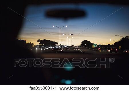 Stock Image - Driving at dusk. Fotosearch