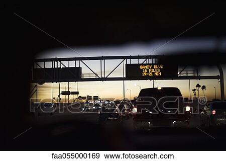 Driving in traffic at sunset View Large Photo Image Stock Photo - Driving in traffic at sunset. Fotosearch