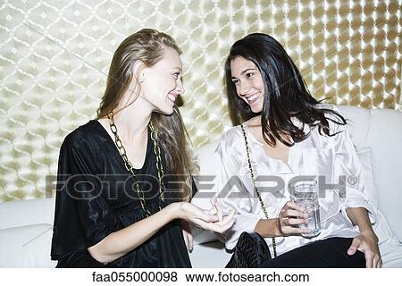 Friends chatting at nightclub View Large Photo Image Stock Photo - Friends chatting at nightclub. Fotosearch