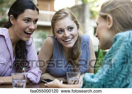 Stock Image - Friends chatting together. Fotosearch