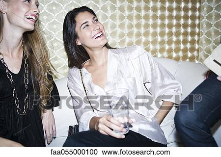 Friends enjoying time out together at night club View Large Photo Image Stock Image - Friends enjoying time out together at night club. Fotosearch