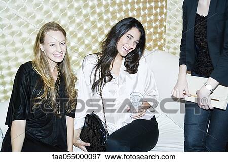 Friends enjoying time together at nightclub View Large Photo Image Stock Photo - Friends enjoying time together at nightclub. Fotosearch