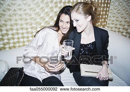 Stock Image - Friends together at night club. Fotosearch