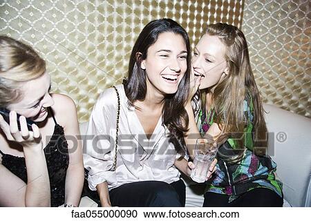 Friends together at night club, women gossiping View Large Photo Image Stock Image - Friends together at night club, women gossiping. Fotosearch
