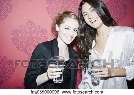 Stock Photograph - Friends together at nightclub, portrait. Fotosearch