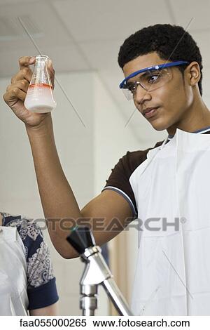 Stock Photography - High school student conducting experiment in chemistry class. Fotosearch