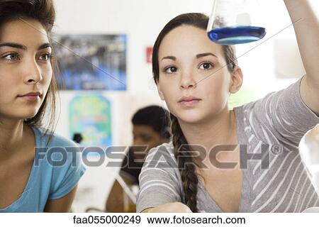 Stock Photo - High school students conducting experiment in science class. Fotosearch