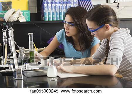 Stock Photography - High school students conducting experiment in science class. Fotosearch