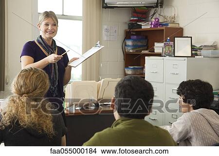 High school teacher addressing students in class View Large Photo Image Picture - High school teacher addressing students in class. Fotosearch