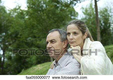 Mature couple relaxing together in park View Large Photo Image Stock Photo - Mature couple relaxing together in park. Fotosearch