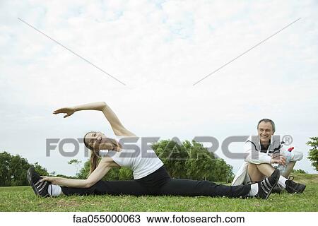 Mature couple stretching in park View Large Photo Image Stock Image - Mature couple stretching in park. Fotosearch