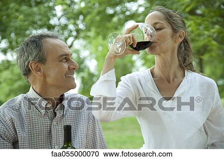 Mature couple together outdoors enjoying glass of wine View Large Photo Image Stock Image - Mature couple together outdoors enjoying glass of wine. Fotosearch