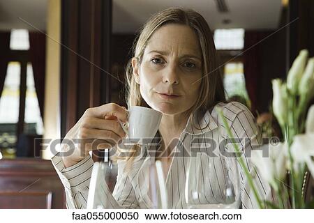 Mature woman having coffee in restaurant View Large Photo Image Stock Image - Mature woman having coffee in restaurant. Fotosearch