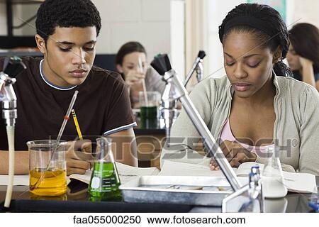 Stock Image - Students completing assignment in chemistry class. Fotosearch