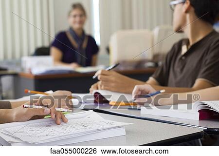 Students completing classwork, cropped View Large Photo Image Stock Photograph - Students completing classwork, cropped. Fotosearch