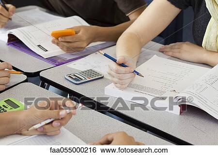 Students completing mathematics assignment together, cropped View Large Photo Image Stock Photograph - Students completing mathematics assignment together, cropped. Fotosearch