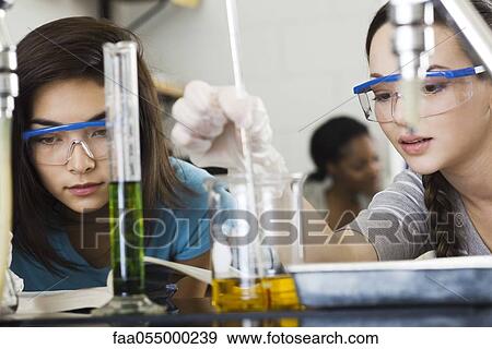 Stock Photo - Students conducting experiment in chemistry class. Fotosearch