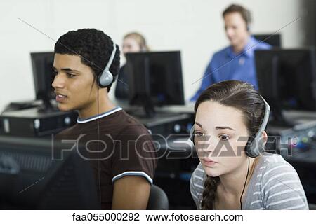 Stock Image - Students learning in computer lab. Fotosearch