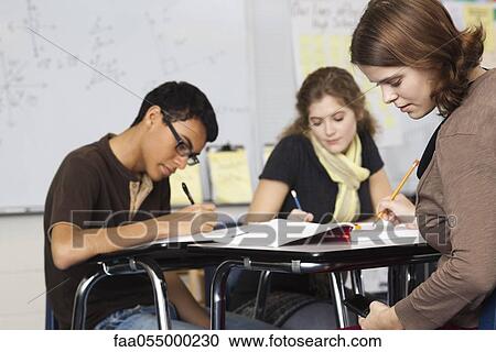 Students working in class, one text messaging under her desk View Large Photo Image Stock Image - Students working in class, one text messaging under her desk. Fotosearch