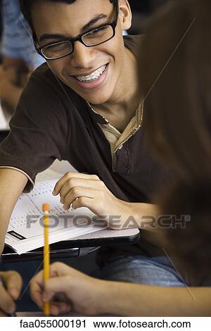 Teen boy helping classmate View Large Photo Image Stock Image - Teen boy helping classmate. Fotosearch