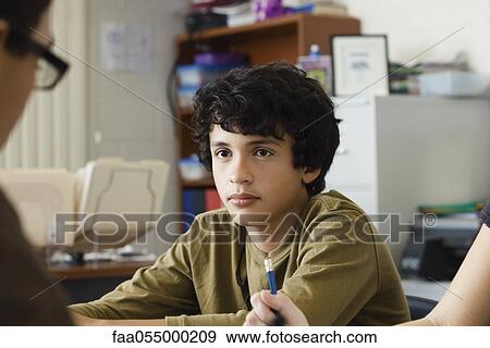 Stock Photo - Teenage boy daydreaming in class. Fotosearch