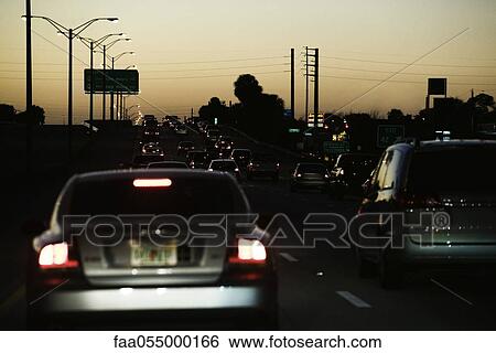 Stock Photograph - Traffic on highway at dusk. Fotosearch