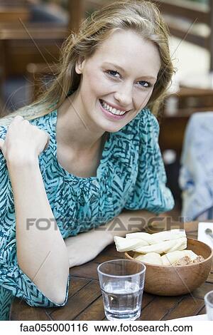 Stock Photograph - Young woman at restaurant, portrait. Fotosearch
