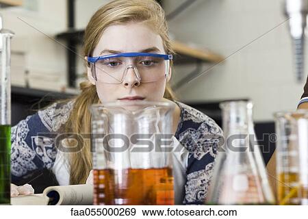 Young woman conducting experiment in chemistry lab View Large Photo Image Stock Photo - Young woman conducting experiment in chemistry lab. Fotosearch