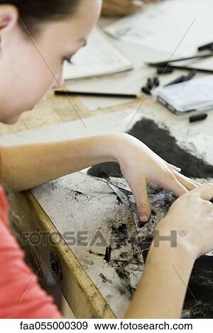 Stock Photo - Young woman drawing with charcoal. Fotosearch